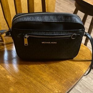 I am selling a Michael Kors bag in the color black and it is a medium size bag.